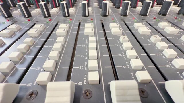 A vintage audio mixing console rests inside Lenfilm in Saint Petersburg. This technical sound equipment evokes a warm feeling of nostalgic wonder and quiet appreciation.