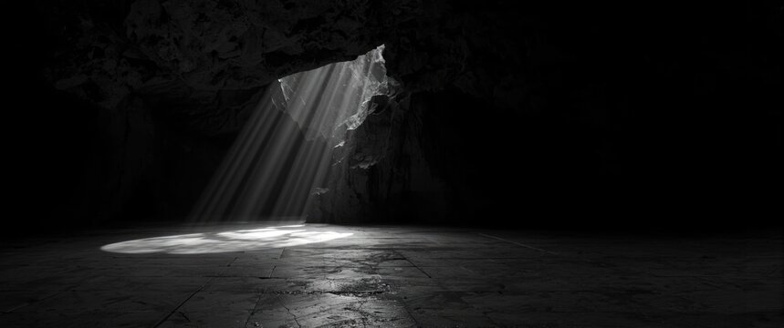 Light rays streaming through a cave opening onto the floor