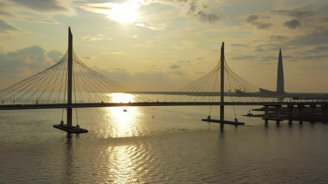 Aerial view of the cable-stayed bridge of the Western High-Speed Diameter with the Lakhta Center skyscraper in the background during a golden sunset, Saint Petersburg, Saint Petersburg, Russia.