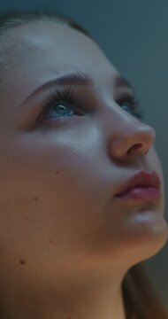 Close Up of Young Female Student Leaning Against School Lockers while Taking Quiet Moment Between Classes. Lifestyle Scene Reflection, Maturity, Inner Strength and Modern Teenage Life. Vertical Shot.