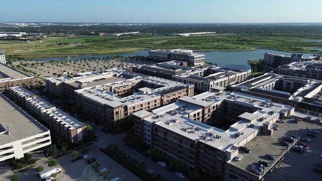 Waterfront apartment complexes border North Lake across prominent Dallas Fort Worth metroplex suburbs. Multi family residential blocks meet scenic open reservoir shorelines, Coppell, Texas
