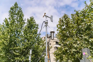 Weather station sensor mast with anemometer and meteorological equipment outdoors © uladzimirzuyeu