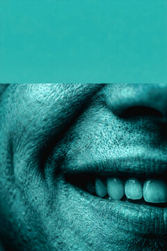 Close-up of a smiling man with textured skin