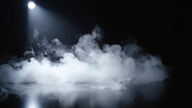 White smoke or fog illuminated by single spotlight on dark reflective surface for artistic effect