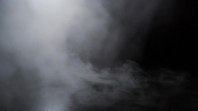 White smoke or fog on black background creating dense mist effect with soft and swirling patterns