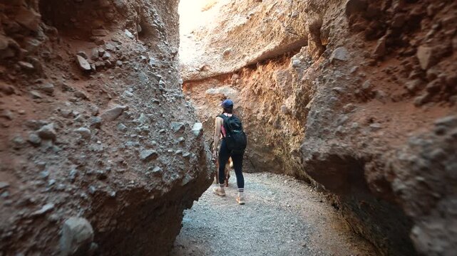 Following Woman WIth Dog Waiting in Very Narrow Canyon, Spooky Gulch in Utah USA