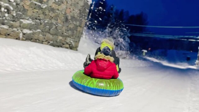 boys riding Hoverboard kart and tubing on winter road in countryside