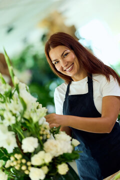 Smiling Female Florist Arranging White Flowers in Boutique Flower Shop for Small Business Branding