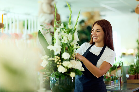 Smiling Florist Arranging White Bouquet in Flower Shop &mdash; Small Business Owner in Apron