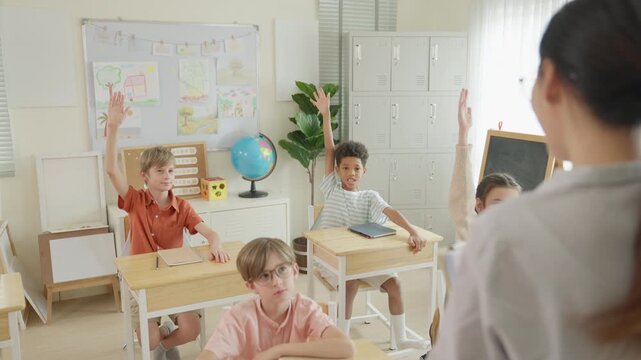 Elementary classroom diverse children and student learning desk during teacher lesson, classroom education with globe artwork, school participation, curiosity, engagement, collaboration