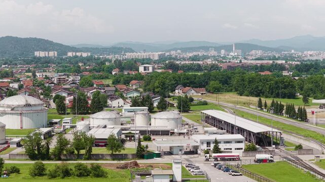 This aerial view shows a petroleum storage terminal with large fuel tanks and industrial structures.