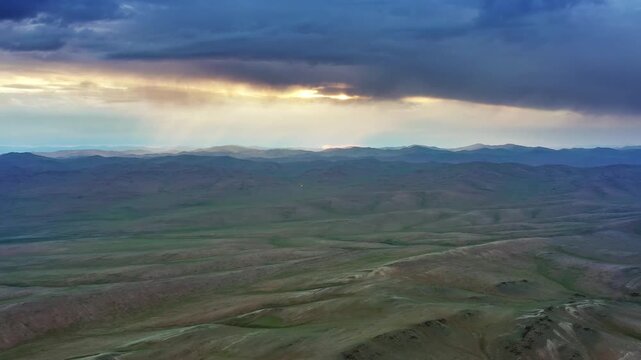 Aerial view of Orkhon Valley Natural and Historical Reserve with rolling hills and dramatic sunset clouds over the landscape in Xarxorin, Ovorkhangai, Mongolia.