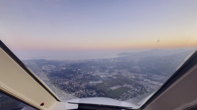 Cockpit point of view hyperlapse shot of a jet aircraft approaching, descending, and landing on runway 35 at Cannes Mandelieu Airport on the French Riviera at sunset