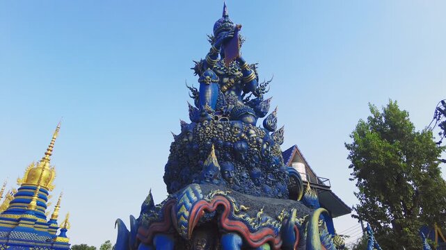 Indra statue at the blue temple entrance in Chiang rai. Thailand modern temple