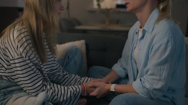 Teenage girl talking with her mother about friendship problems, peer pressure and social challenges, showing emotional distress and family support during adolescence.