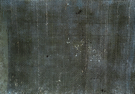 Old, dirty, metal dust-covered screen mesh texture, macro background, overhead view.