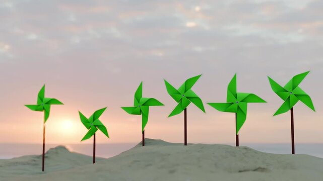Green pinwheels on sand dunes at sunset with soft clouds