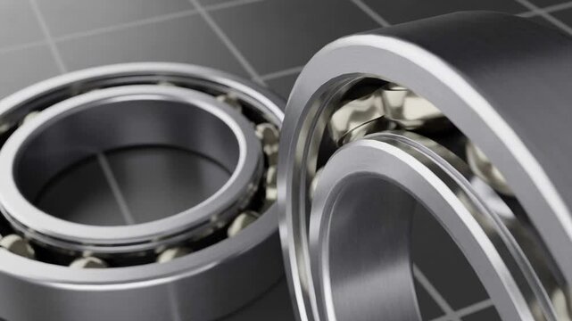 Close-up view of precision ball bearings rotating on a grid background