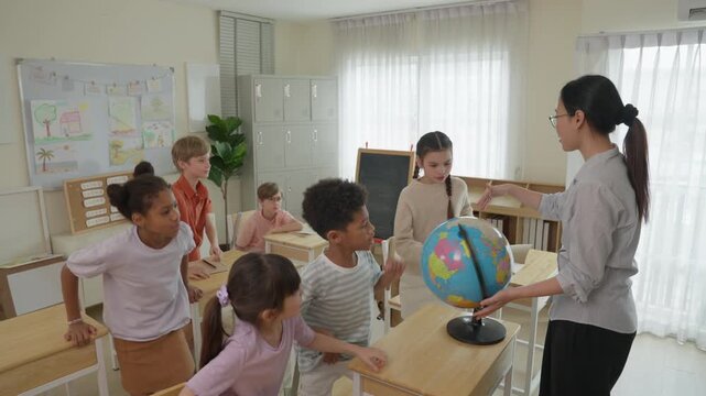Teacher Guides Elementary Students Through Engaging Geography Lesson With Globe in Bright Classroom, Supporting Collaborative Learning, Education, and Diverse School Student Understanding