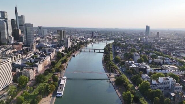 Aerial view of Westhafen Tower and the Frankfurt skyline along the Main river with bridges and urban architecture in Frankfurt am Main, Hessen, Germany.