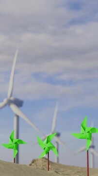 Wind turbines and small pinwheels on a sandy landscape under a cloudy sky