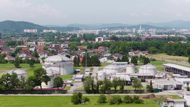 Aerial view shows a petroleum storage facility with multiple tanks and pipelines. This site supports fuel distribution and energy supply.