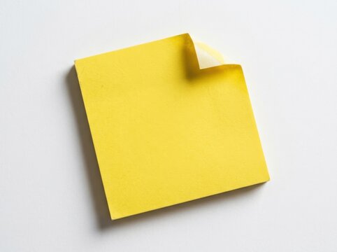 Yellow sticky note with curled corner isolated on white background