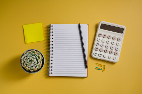 Small business financial planning with calculator and notebook, top view with copy space
