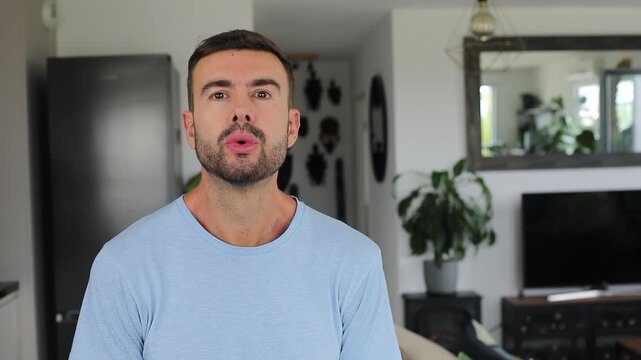 Handsome man closing eyes and breathing mindfully at home alone