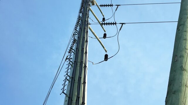 High voltage power line insulators on industrial metal utility pole