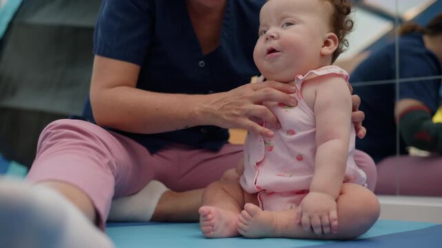 Baby engaging in a physical therapy session with a healthcare professional, focusing on early intervention and motor skill development