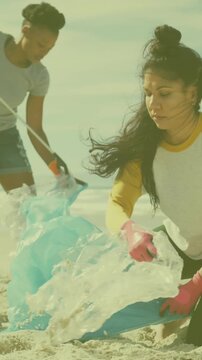 Animation of ecology icon over diverse volunteers segregating waste