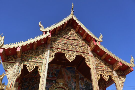 Traditional Thai temple structures and ornate details at Wat Phra That Doi Kham in Chiang Mai. Perfect for travel photography, cultural projects, and designs highlighting the rich religious art.