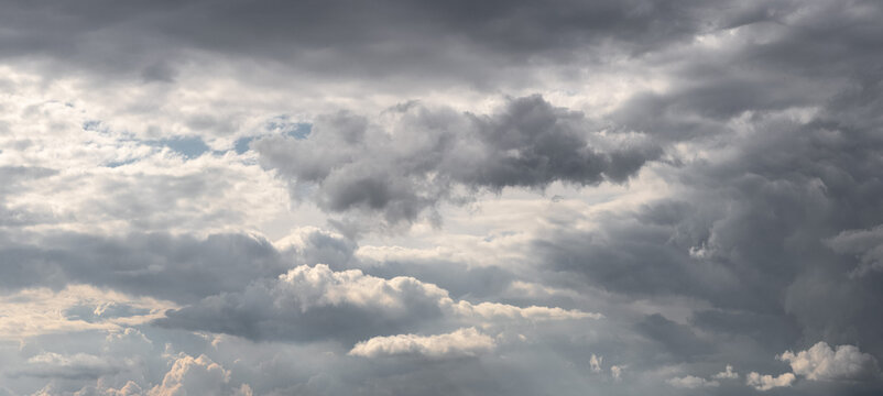 Dramatic cloudy sky with heavy gray and white storm clouds