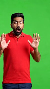 Vertical video of man reacting with shock against green screen
