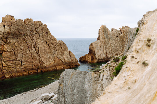 A stunning seascape with large cliffs jutting out of the water. A coastline with large cliffs in the background. Concept of nature and beauty.