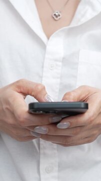 woman holds smart phone in her hands and scrolls through the news feed. Close up of hand uses mobile. point finger on screen, texting text message.	