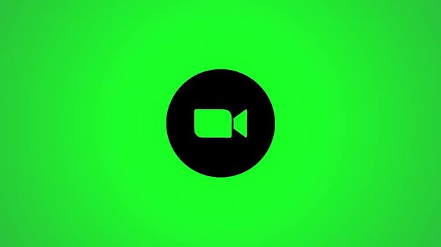 A black video camera icon gracefully rotating and zooming in on a vibrant green screen background perfect for digital media projects.