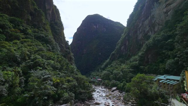 Aguas Calientes town Machu Picchu entrance Amazon Urabumba river dry rainy season afternoon Peru Peruvian Andes Mountains jungle lower highlands Inca trail citadel hotels landscape static shot