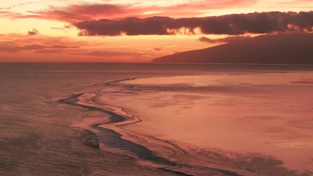 Tahiti coastline orange red golden hour sunset Teahupo'o coral reef lagoon aerial drone French Polynesia Mount Orohena South Pacific Ocean island Passe Havea harbor view landscape up pan right