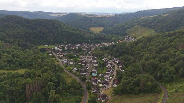 Aerial push in shot of the scenic village Wein&auml;hr in Rhineland-Palatinate, Germany. Surrounded by lush hills and vineyards.