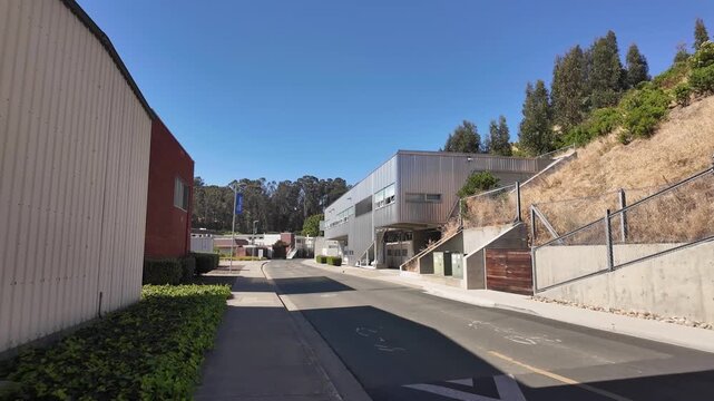 Forward moving view of the California State University Maritime Academy, also known as Cal Poly Maritime Academy, campus located in Vallejo, showing modern architecture and sunny skies