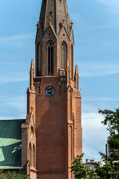Vertical urban architecture photo of red brick church tower real life photography