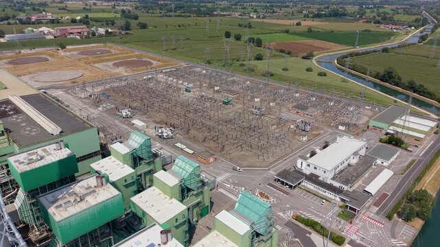 Aerial footage of a major power generation facility in Northern Italy, showing large industrial structures and energy infrastructure within the Lombardy landscape.