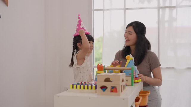Mother Daughter Play Colorful Wooden Toy Bright Home Family Activity Celebrating Birthday With Colorful Cake During Joyful Creative Indoor Moment Together