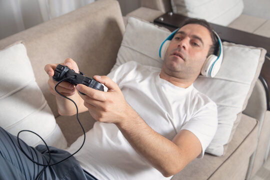 Man playing video game using game controller.