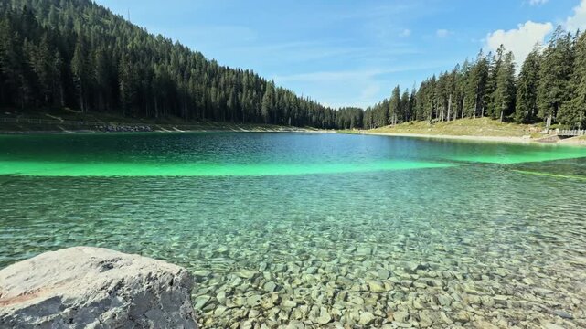 Beautiful mountain landscape with the san giuliano lakes in trentino, italy. Clear turquoise water reveals the rocky bottom on a sunny day
