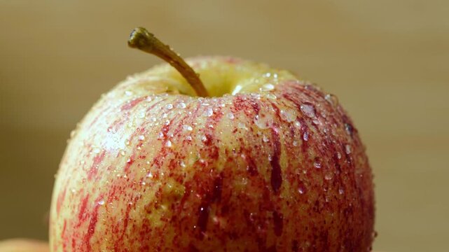 Close-Up of Red Apple Covered with Water Droplets	