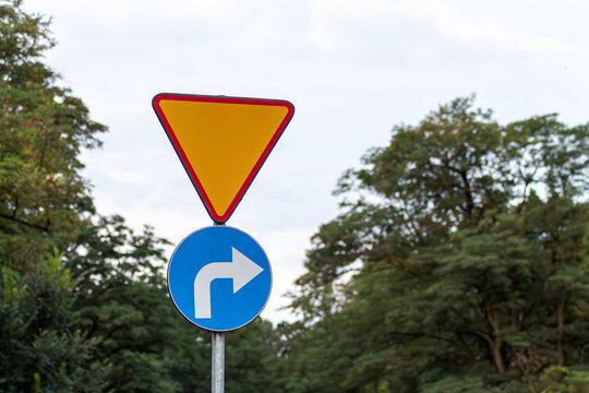 Horizontal urban photo of yield sign and right turn traffic sign real life photography