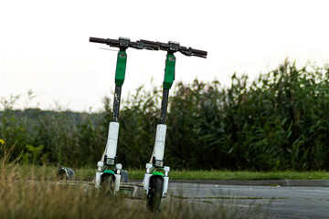 Horizontal minimal urban photo of two electric scooters on quiet roadside © Artem